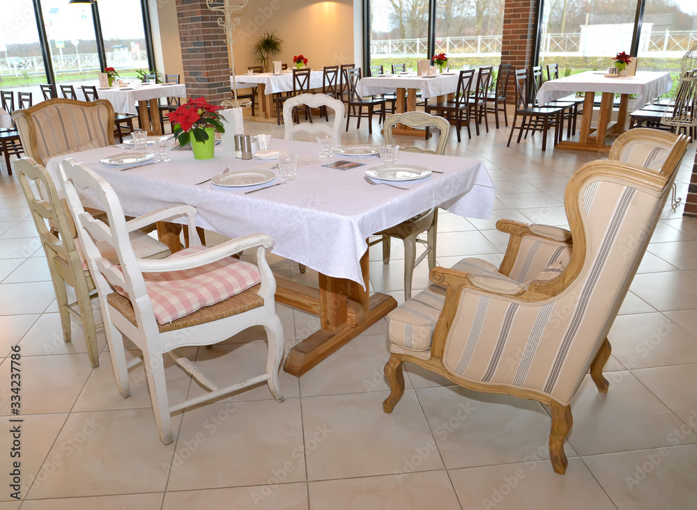 Served table and chairs in the restaurant room. Interior