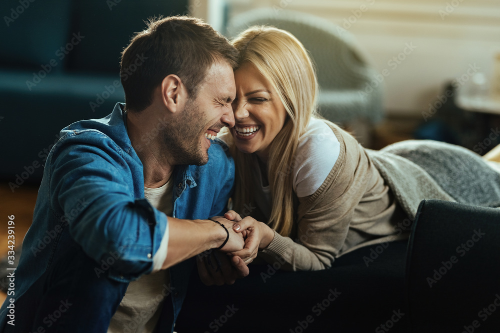 Young couple having fun and laughing while spending time at home. Young couple having fun and laughing while spending time at home.