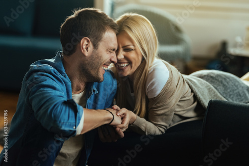Young couple having fun and laughing while spending time at home.