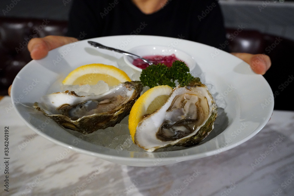 oysters on the half shell served flat lay in a white plate
