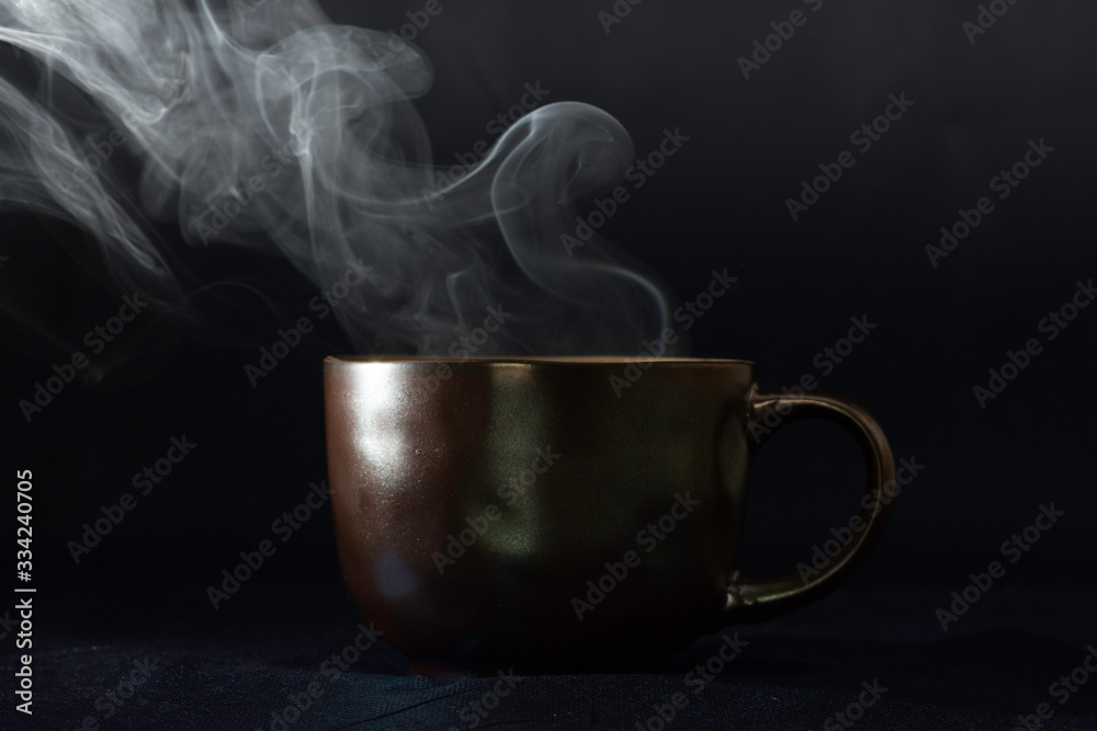 Fototapeta premium steaming cup on black background