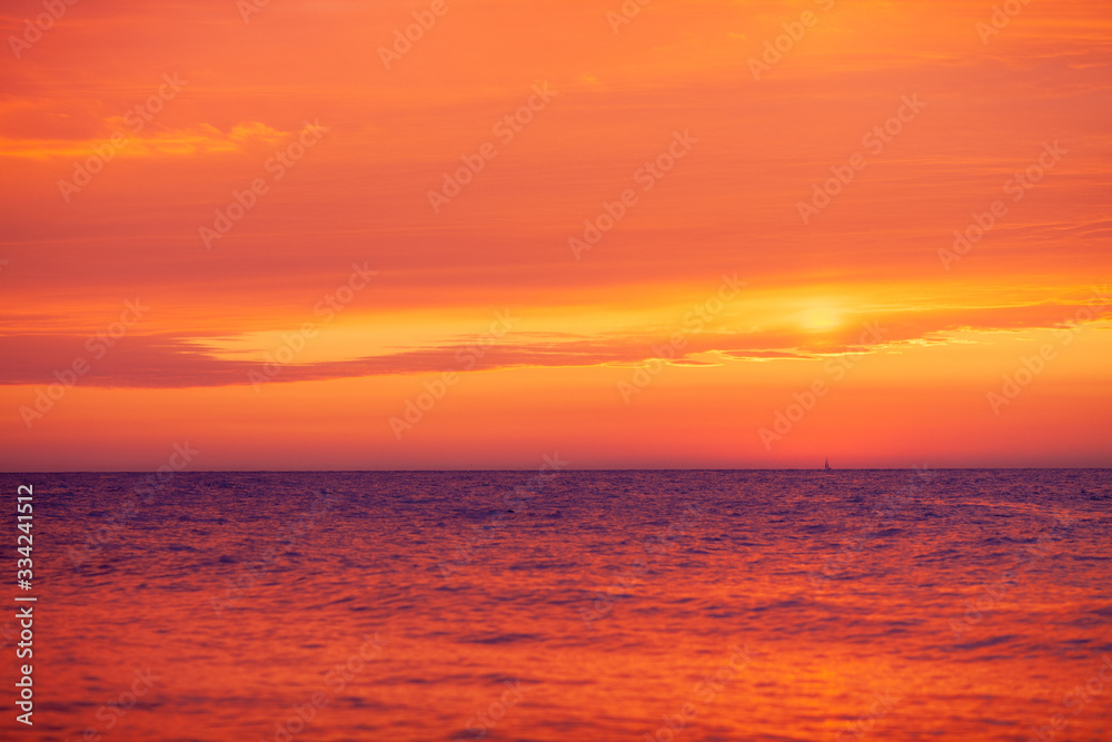 beautiful red-orange sunset on the sea, colorful sky and sea, magical landscape