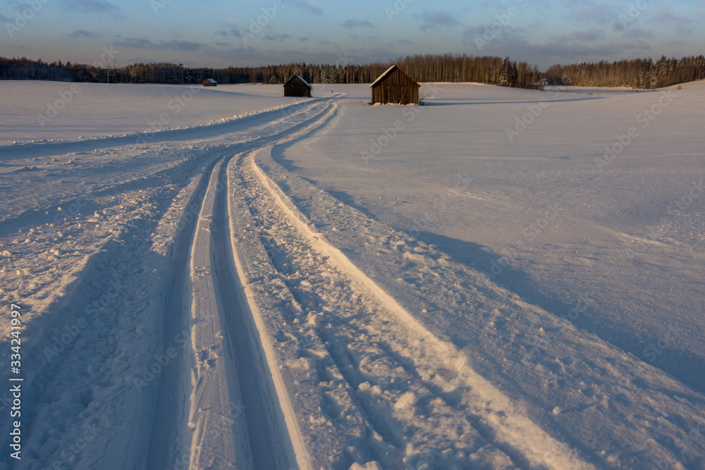 Old barns in snowy field