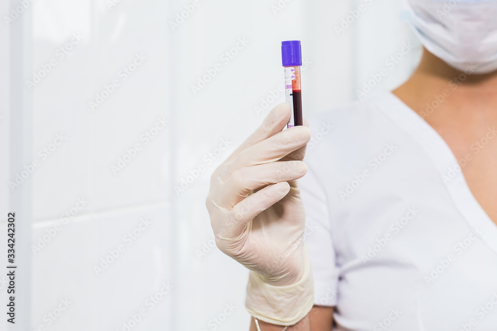 Covid-19, coronavirus, pandemic and viruses concept - woman holding blood in tests tubes close up, background with copy space. Covid-19, coronavirus, pandemic and viruses concept - woman holding blood in tests tubes close up, background with copy space.