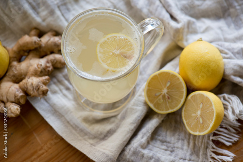 Lemon ginger drink in dark light with a soft cloth and texture