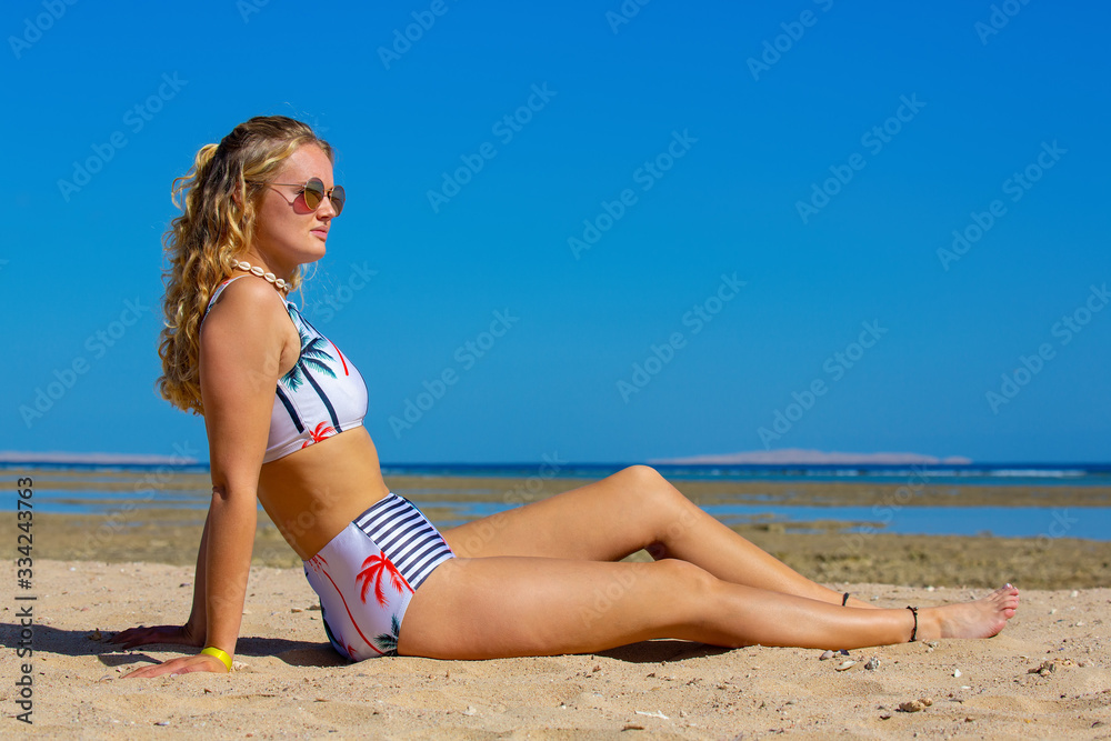 Pretty young dutch woman sits on beach Pretty young dutch woman sits on beach