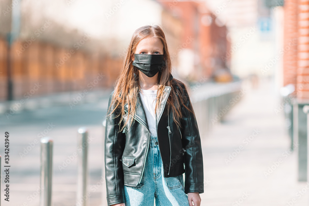 Girl wearing a mask protect against Coronavirus and gripp