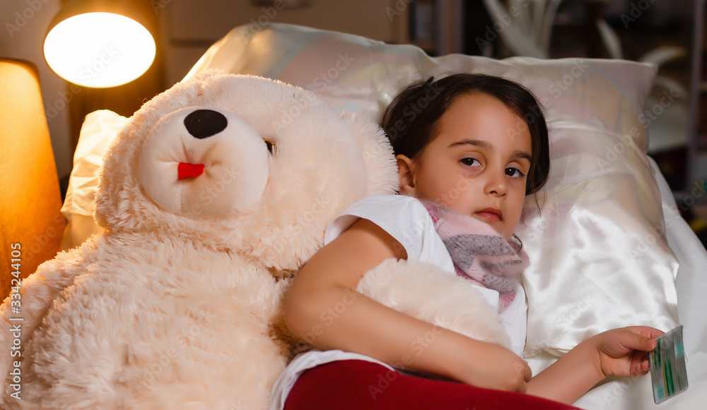 Little girl with illness on the bed