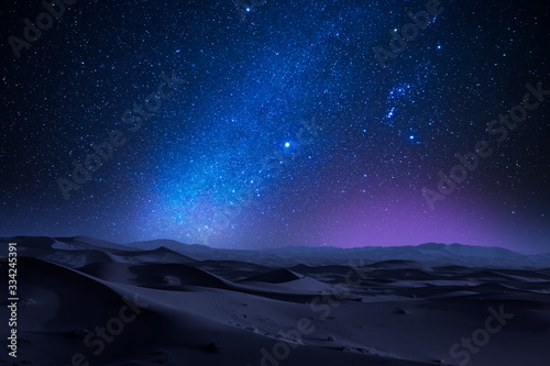 Starry night in the desert with dunes photo