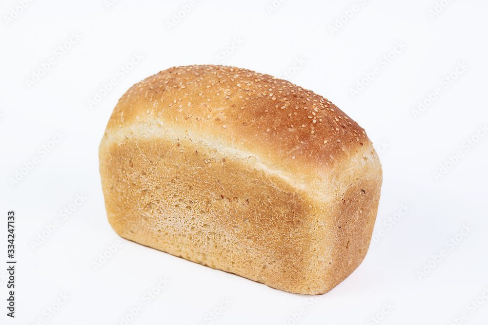 Bakery product. Fresh white molded bread with sesame seeds isolated on white background. Top view and copy space for text. Bakery product. Fresh white molded bread with sesame seeds isolated on white background. Top view and copy space for text.