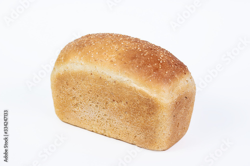 Bakery product. Fresh white molded bread with sesame seeds isolated on white background. Top view and copy space for text.