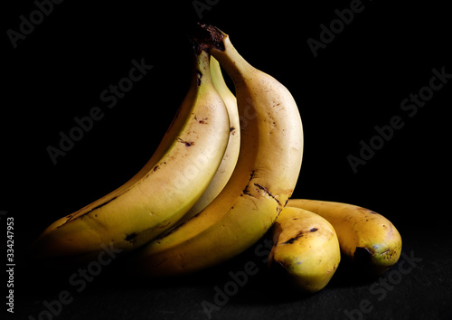 Bilde på lerret Canarian banana still life Spain chiaroscuro isolated on a black background dark