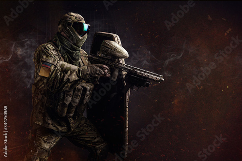 Paintball. Tactical assault male fighter with shield