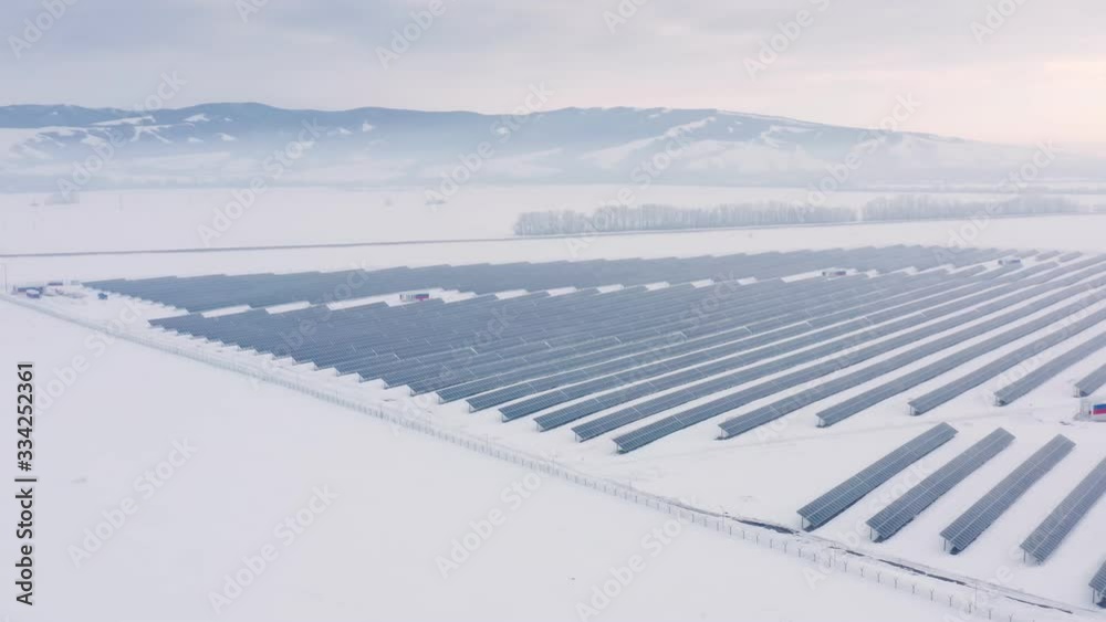 Aerial perspective Solar panel farm Green Energy at winter snow sunny day drone shot of Ecology Power Conservation Aerial perspective Solar panel farm Green Energy at winter snow sunny day drone shot of Ecology Power Conservation