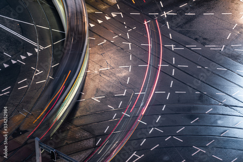 Fast blurred trail of train in traffic motion in illuminated metro, Netherlands.