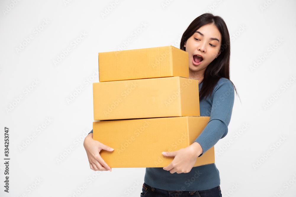 Happy Asian woman holding package parcel box, Delivery courier and shipment service concept Happy Asian woman holding package parcel box, Delivery courier and shipment service concept