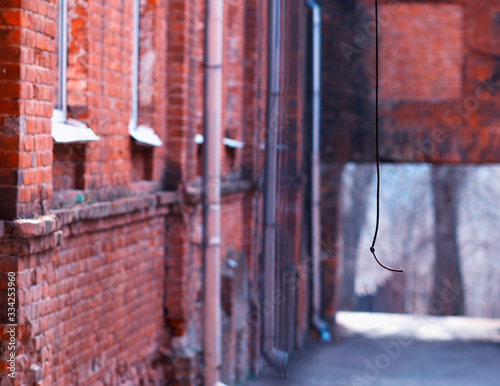 Vertical wire at red bricked yard background