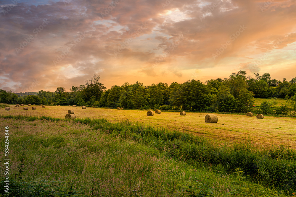 Fototapeta premium Hay bales with sunset