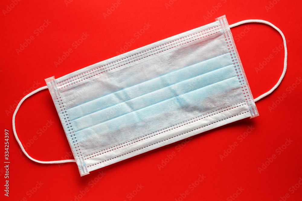 medical mask on a red background close-up medical mask on a red background close-up