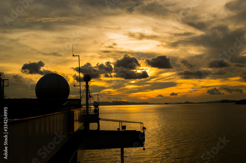 Sunset with ship radar silhoutte photo