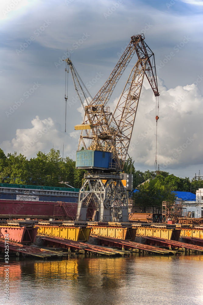 Elevating complex for transshipment of grain and oilseeds as part of a reloading terminal. Transportation of agricultural products and port cranes - Image. Elevating complex for transshipment of grain and oilseeds as part of a reloading terminal. Transportation of agricultural products and port cranes - Image.