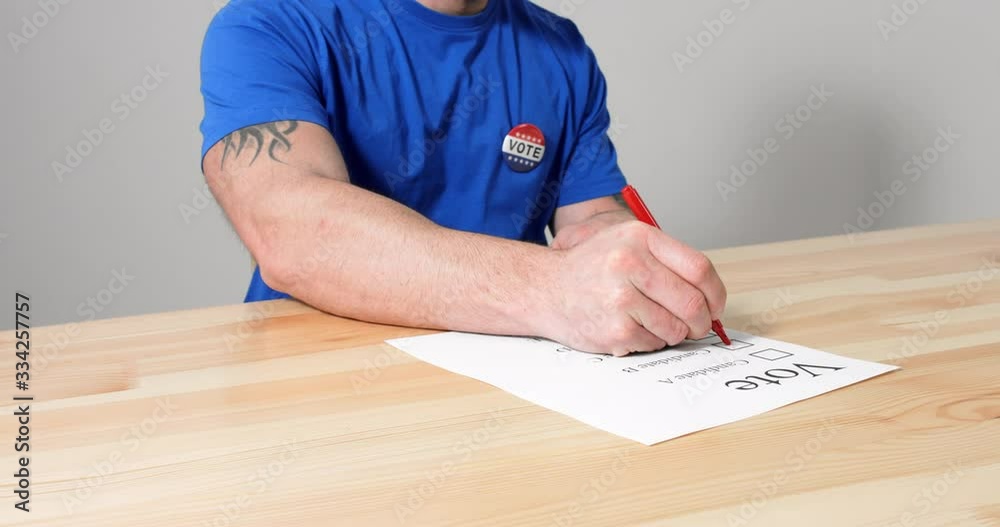 American voter marks his candidate on a paper ballot for US Presidential Elections. American voter marks his candidate on a paper ballot for US Presidential Elections.