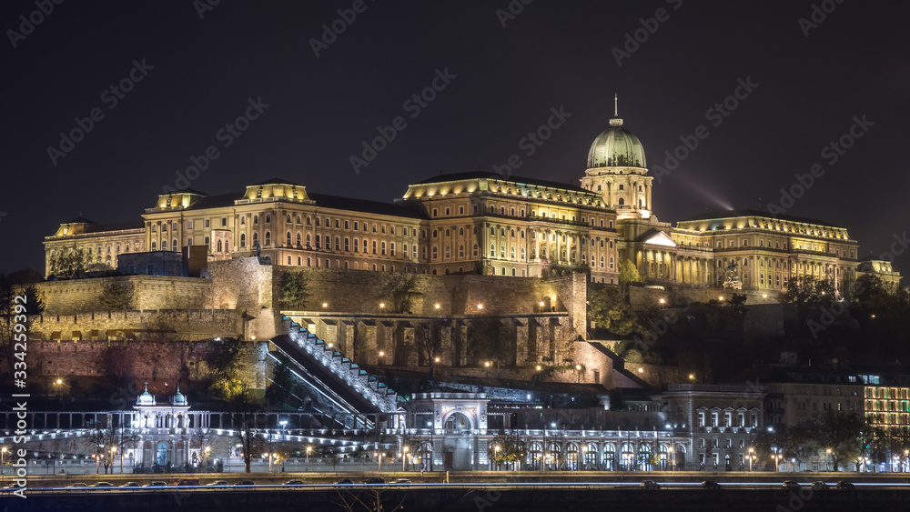 Buda Castle by the Danube river illuminated at night in Budapest, Hungary