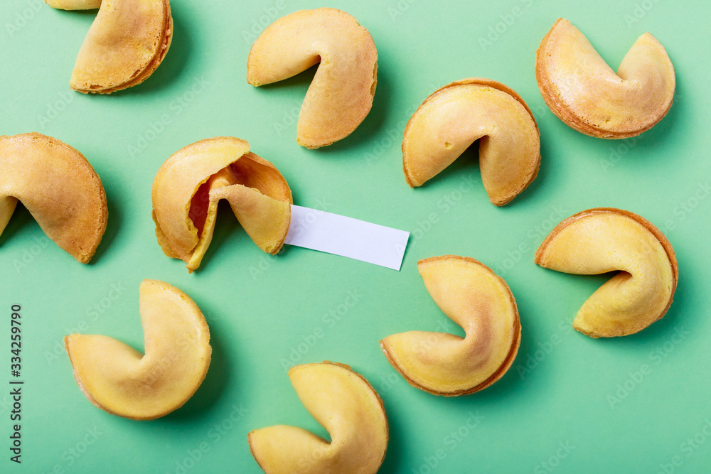 Fortune cookies on a green background, close-up.