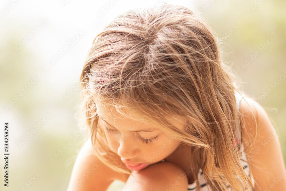 Little blonde girl with head bowed, looking down Little blonde girl with head bowed, looking down