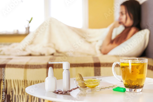 sick woman is laying in the bed with medicine