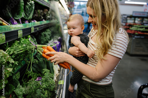 mother and daughter shopping for organic vegetables