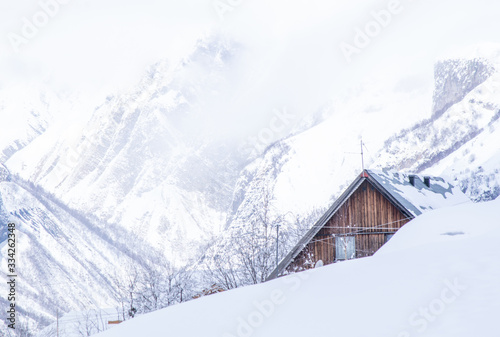 Lonely wooden cabin hidden in the mountains. Winter holidays destination in Georgia.2020 © Evaldas