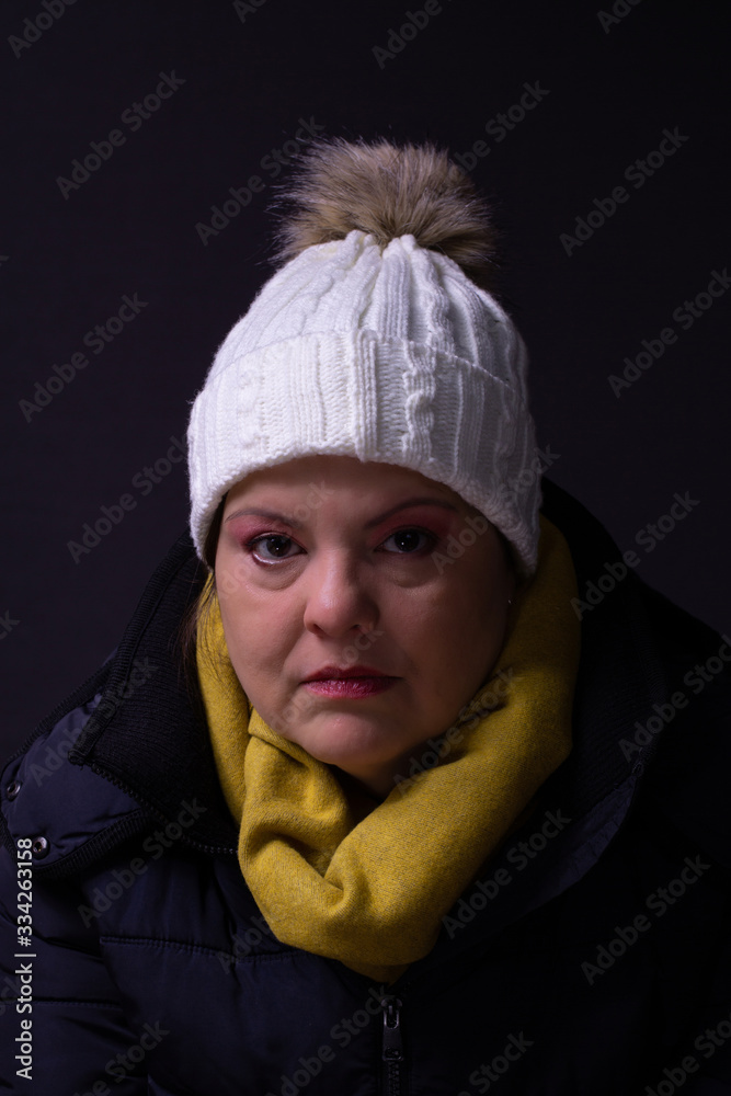 Lady headshot portrait. She is a caucasian woman in her 40s. She is looking at the camera and wearing her winter clothes: jacket, hood and scarf. Lady headshot portrait. She is a caucasian woman in her 40s. She is looking at the camera and wearing her winter clothes: jacket, hood and scarf.