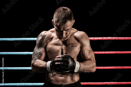 Mixed martial artist posing in boxing ring фототапет