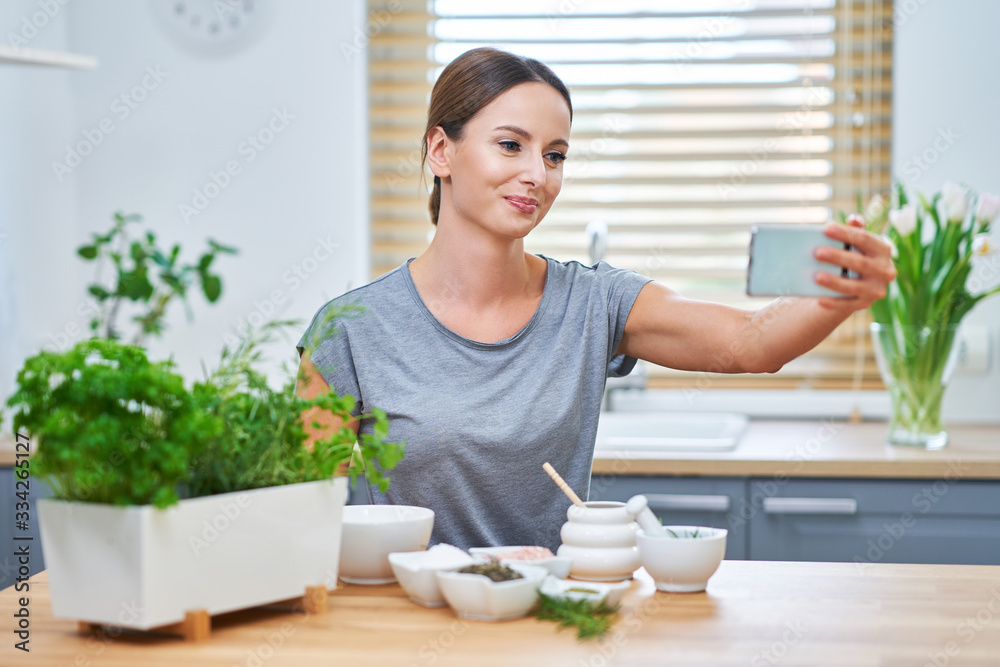 Beautiful healthy woman preparing natural cosmetics at home Beautiful healthy woman preparing natural cosmetics at home