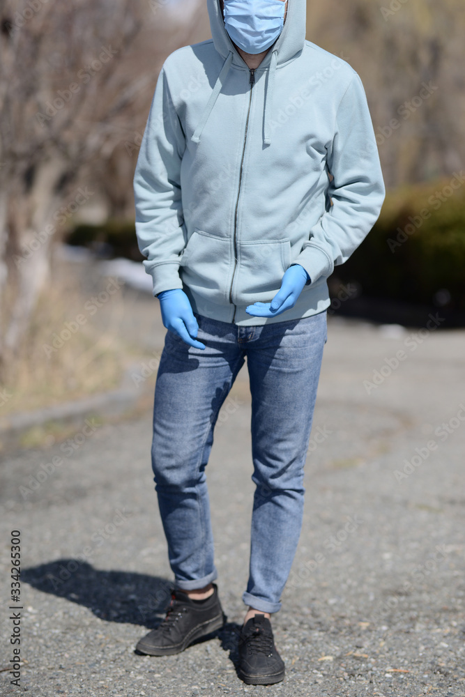 A young man with medical half face mask and gloves A young man with medical half face mask and gloves