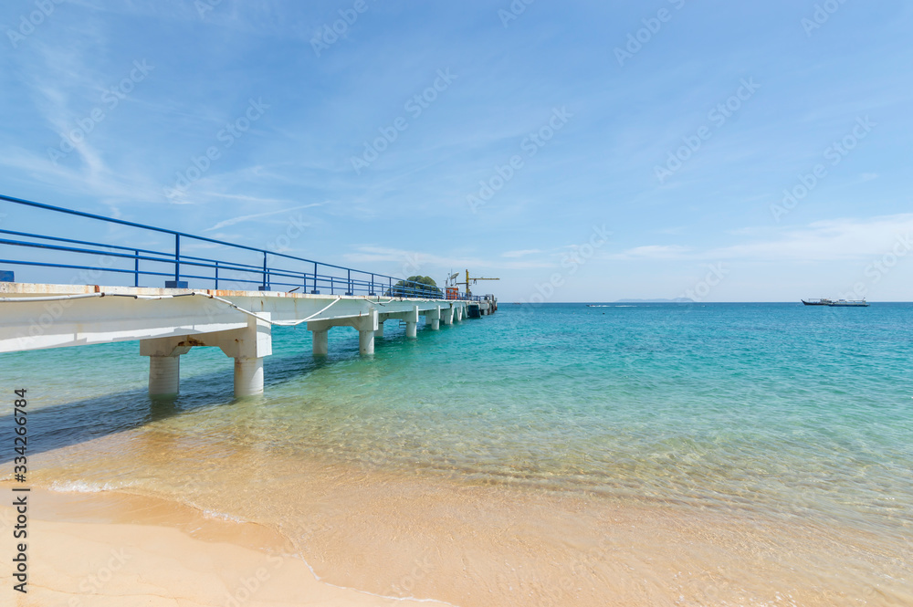 Jetty with clear water and blue skies