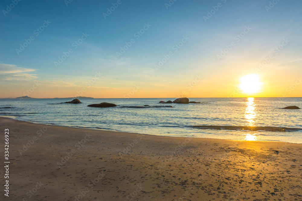Beach wave with orange sunrise background