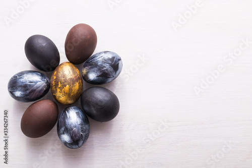 Holidays, design and modern easter concept - Black and brown easter eggs style minimalism on white background with copyspace.