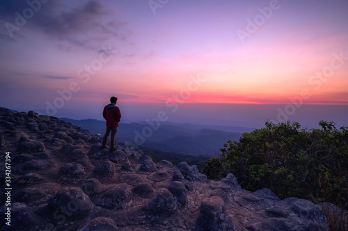 Tourists stand and watch the sunset over the rocky landscape at Phu Hin Rong Kla National Park  Phitsanulok Province.