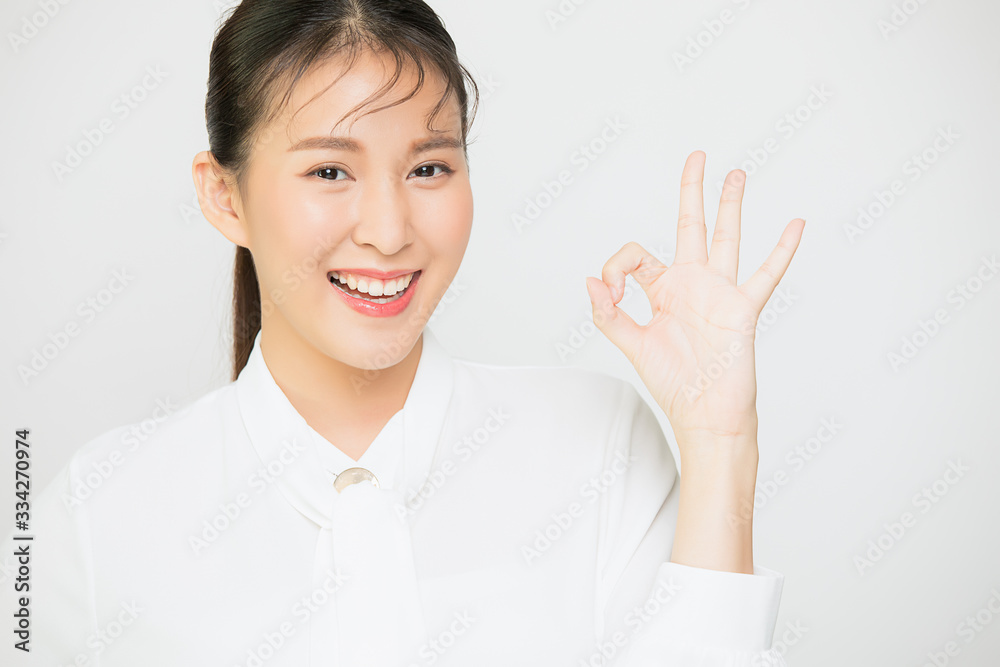Asia girl with, showing okay excellent gesture and smiling, say yes, confirm or recommend something, white background Asia girl with, showing okay excellent gesture and smiling, say yes, confirm or recommend something, white background