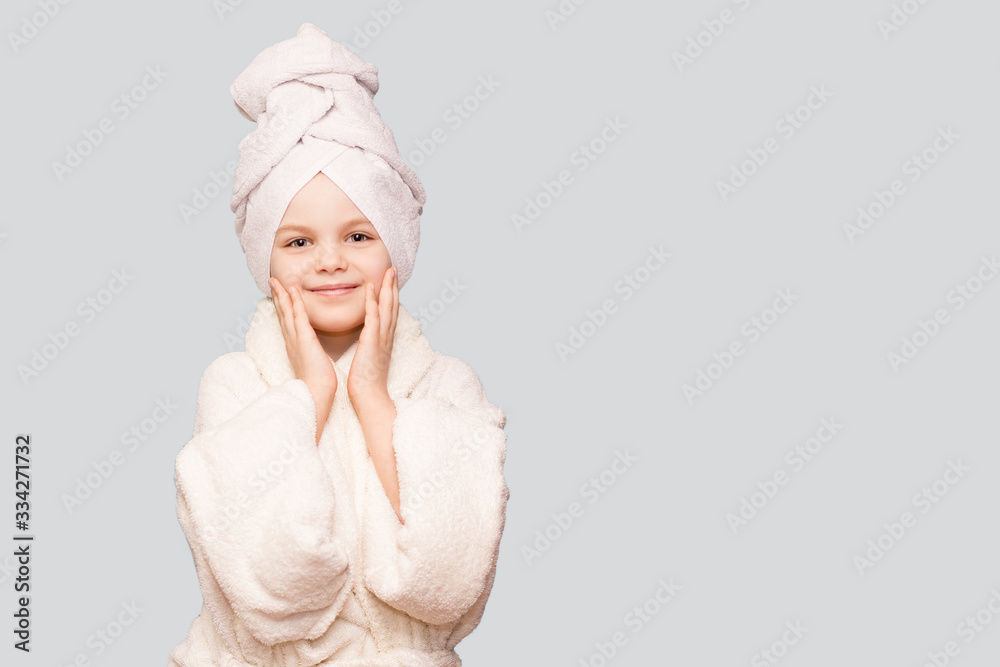 Spa skin care beauty girl wearing hair towel and white coat after beauty treatment. Beautiful child girl with perfect skin Spa skin care beauty girl wearing hair towel and white coat after beauty treatment. Beautiful child girl with perfect skin