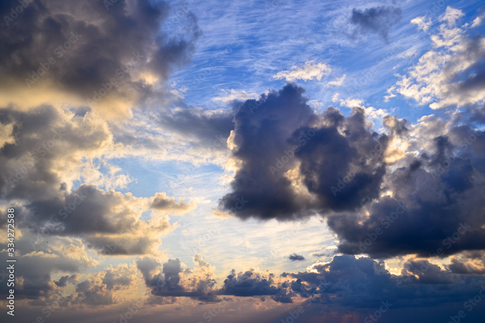 Fototapeta premium Bright colorful cloudy sky at sunset. Copy space for background