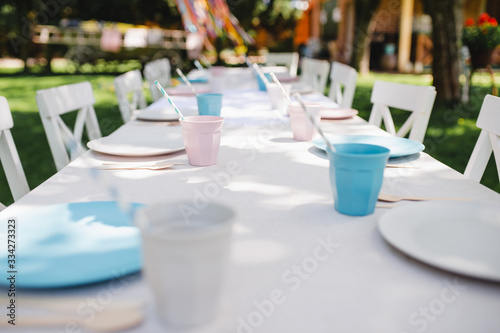 Table set for summer garden party, birthday celebration concept.