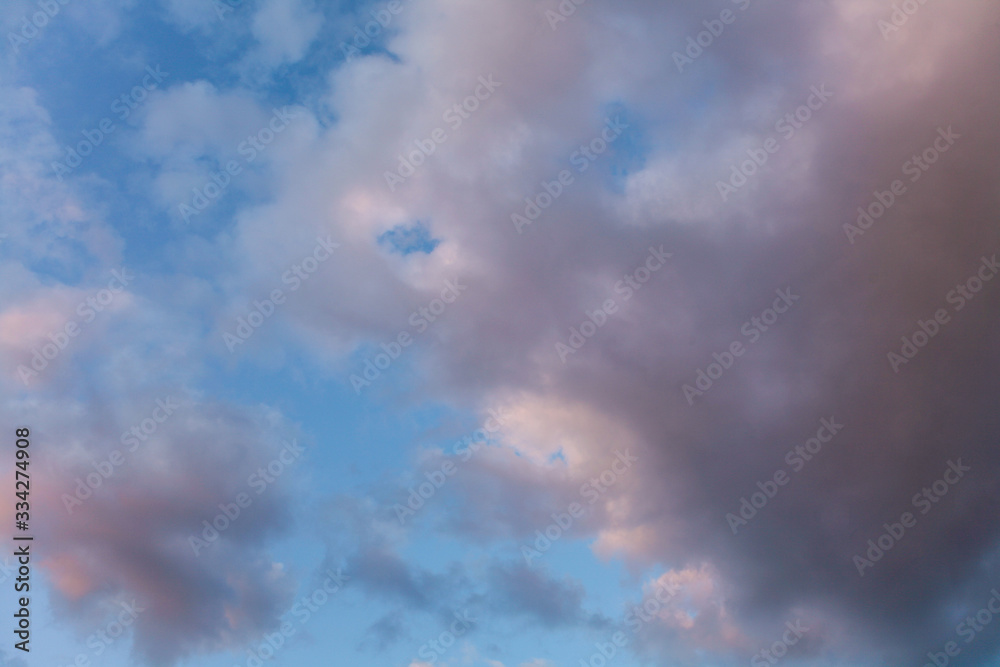 Fototapeta premium large pink cloud in a blue sky with space for text
