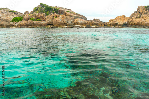 Rock island and clear water with low angle view