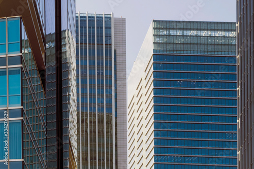 Abstract modern urban blue, brown and gray evening background featuring details of modern skyscrapers in financial downtown Tokyo, Japan.