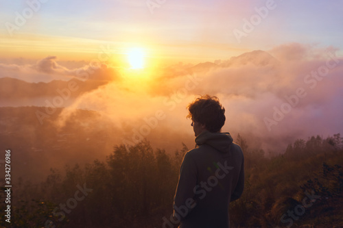 silhouette of man on top of the mountain at sunrise © Nat