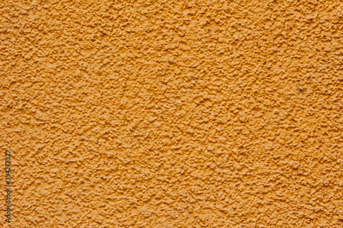 Bright yellow decorative stucco texture
