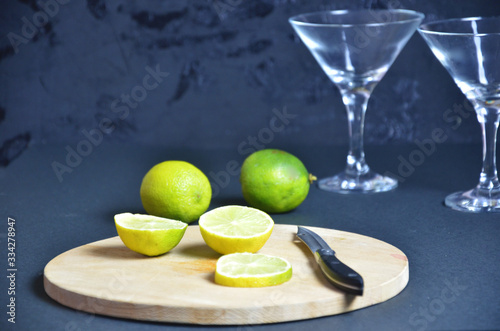 two empty glasses for making margarita cocktails with lime on a black background Margarita cocktails shot on a bar counter in a nightclub photo